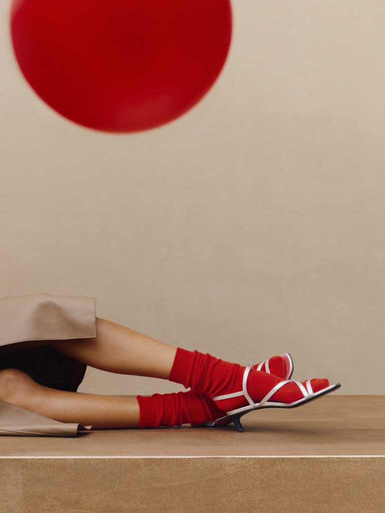 Minimal studio set design with bold red elements for Hermès by Paris-based set designer Nara Lee (Nara Lee Studio)